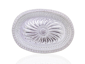 A silver oval decorative serving tray with an intricate floral pattern, viewed from directly above.