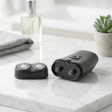 Portable electric shaver in hand showing compact size and sleek design