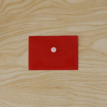 Hand holding a plastic document folder envelope, showing its transparency.