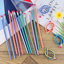 Swirl pencils on a desk with a notebook & supplies