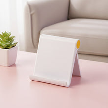 Close-up of foldable plastic desktop mobile stand with smooth white finish