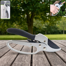Silver and black pruning shears on a wooden surface with a blurred green background and packaging inset. – view 3