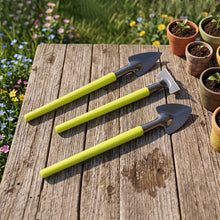 A person using the Mini Gardening Tool Set for planting a small seedling.