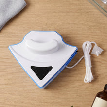 Magnetic window cleaner in use on glass