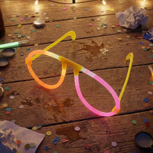 Close-up of glow party glasses with bright neon light