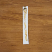 Close-up view of the golden gold tone beaded necklace chain beads