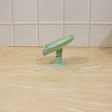 Waterproof plastic soap holder, wall mounted with suction cups in a bathroom environment