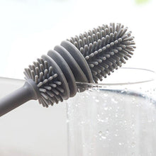 Hand holding a bottle cleaning brush, demonstrating its comfortable grip.