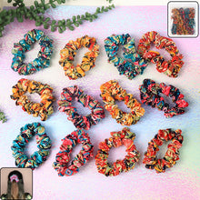 Set of 12 printed fabric hair scrunchies with various vibrant patterns