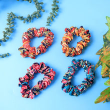 Close-up of assorted printed fabric hair scrunchies showing vibrant patterns