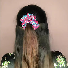 Model wearing a soft printed fabric hair scrunchie