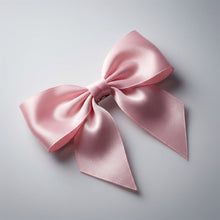 Satin hair bow clip showing smooth fabric and bow design for hair styling