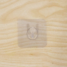 Wall hook on wooden door with transparent adhesive
