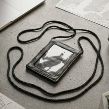 Close-up of the black PU leather neck wallet showing the clear ID window