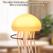 Close-up of the jellyfish lamp showing its glowing yellow dome and rotating tentacles with arrows indicating movement.