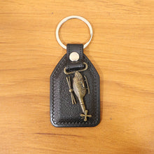 Full display of stylish leather and metal sword emblem keychain