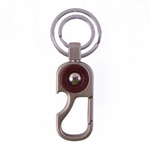 Modern design metal key holder that clips easily onto belts and bags.