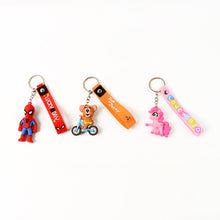 Detailed view of the metal hook and silicone strap on a cartoon silicone keychain.