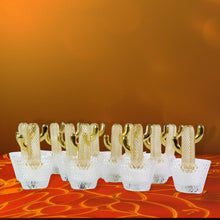 Close-up of decorative cactus LED tealight candle with warm glow