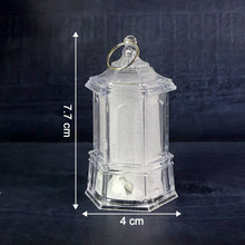 A single clear plastic lantern is shown with white measurement arrows indicating a height of 7.7 cm and a width of 4 cm.