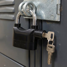 Safora Security Alarm Padlock securing a sturdy metal gate, demonstrating its anti-theft use.
