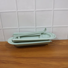 Telescopic sink storage rack installed in modern kitchen setting