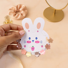 Colorful mini hair claw clips for kids shown clipped open