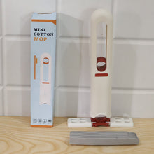 A white and red mini mop with a detached grey sponge head next to its