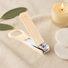 Nail clipper featuring precision curved blades and stabilizing finger loop