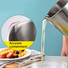 Pouring strained oil from stainless steel oil strainer pot