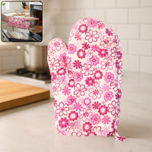 Vibrantly patterned multicoloured oven mitt and pot holder set on a kitchen counter.
