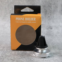 Rotating magnetic phone holder securing a smartphone on a car's air vent.