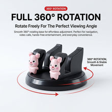 A black phone holder with two pink pig figurines, illustrating its 360-degree rotation capability.