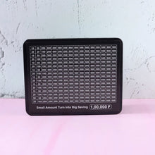 Side view of reusable savings tracker money box with goal chart