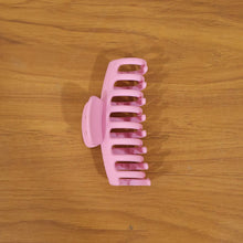 Model wearing elegant pink hair claw clip in styling