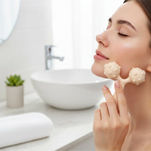 Facial massager with dual rolling balls for improved skin elasticity