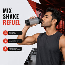 A man in a black tank top drinks from a grey and black shaker bottle in a gym, with text 