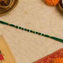 Cotton green thread rakhi featuring pearl and golden beads