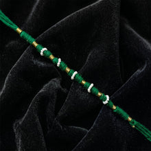 Close-up of green pearl beaded rakhi design