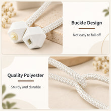 Close-up of the white geometric plastic buckle design and the braided polyester rope of the tieback.