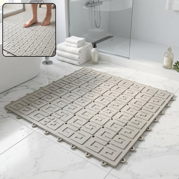 Grey non-slip bathroom mat with textured surface and drainage holes for safety in wet areas