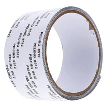 A close-up, angled view of a roll of grey mesh repair tape with white backing, showing the side and top.