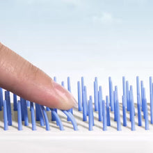Close-up view of the Self-Cleaning Hairbrush's innovative massage bristles
