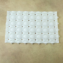 Person standing on textured anti-slip massage bath mat