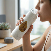 Office-ready glass water bottle with built-in phone stand