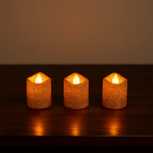 Safe flameless LED tealight candles with glitter finish on shelf