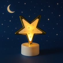A single glowing star-shaped LED light against a dark blue background with a crescent moon and small stars.