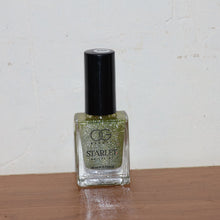 Starlet glitter nail paint shimmering on nails in Sunshine Gold shade