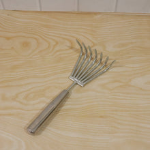 Garden rake being used for garden maintenance and raking