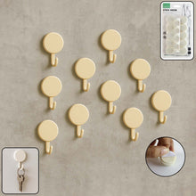 Set of 10 self adhesive round wall hooks arranged neatly for home organization